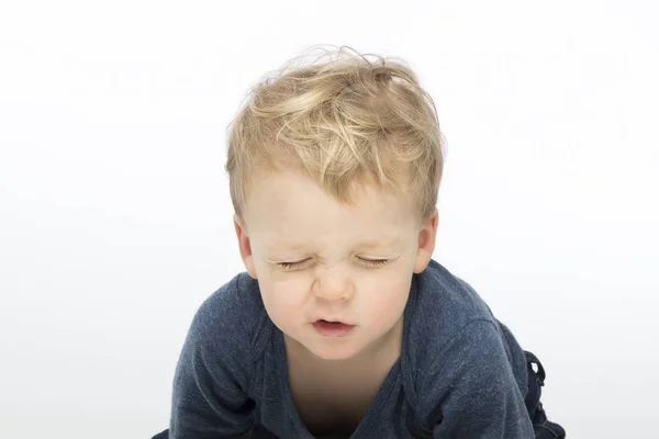 Screwed-up toddler on white background. Studio shot — Stock Photo, Image