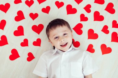 Yerde yatan küçük bir çocuk. Mutlu Sevgililer Günü kavramı.