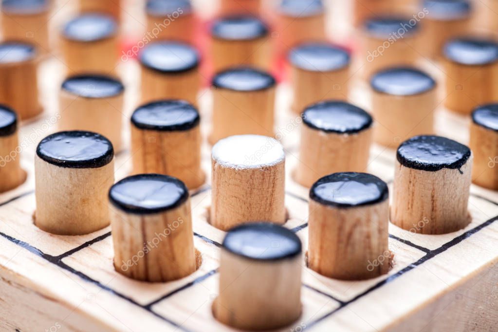 the one white in black of  Wooden Revessi Othello game close up 