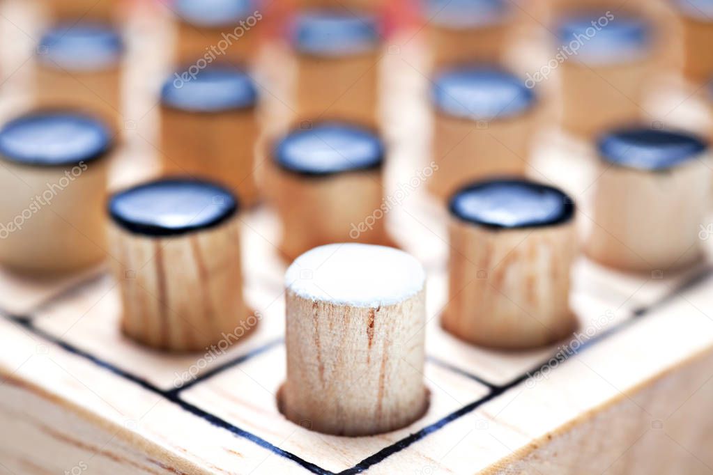 the one white in black of  Wooden Revessi Othello game close up 