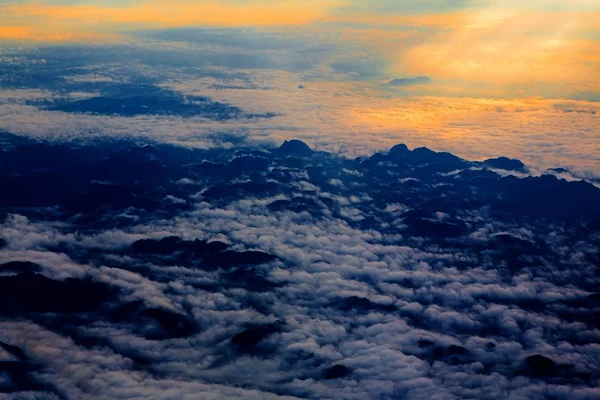 Aerial sky with clouds at sunset or sunrise. above from airplane — Stock Photo, Image