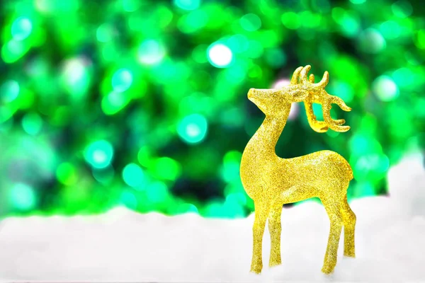 gold deer in snow on glittery background in Christmas