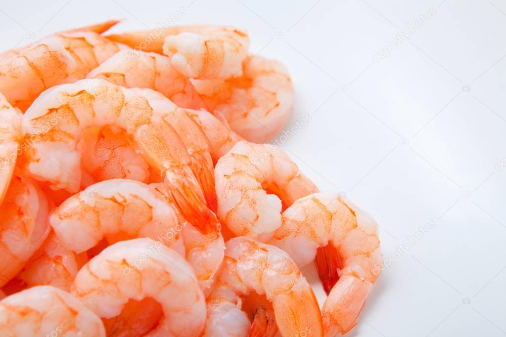 Pile of boiled peeled shrimps isolated on white background