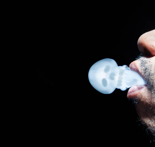 Man smoking a cigarette smoke formed skull dead kill on black — Stock Photo, Image