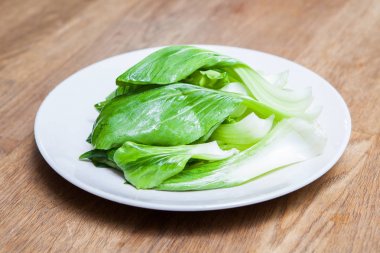 Pak Choy or Chinese Cabbage on white plate clipart