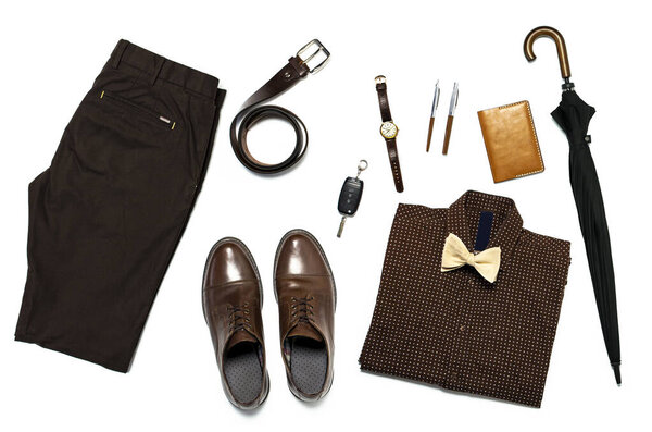 Flat lay set Men's classic clothing, jacket pants shirt bow tie leather belt shoes wrist watch wallet pens umbrella cane car keys isolated items on white background top view. Male fashion, business