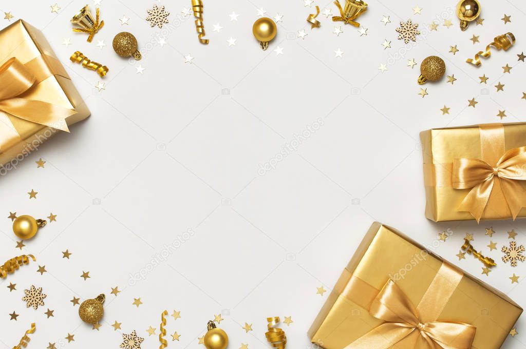Merry Christmas and Happy Holidays greeting card. Beautiful golden gift balls ribbons confetti stars on gray background top view Flat lay. New Year presents Festive decorations party 2020 celebration