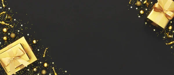 Neujahrs- oder Weihnachtskomposition. Goldgeschenk mit Schleife, Weihnachtskugeln, Konfettisternen auf schwarzem Hintergrund. flache Lage, Draufsicht, Kopierraum. Goldene Dekoration, Party, Urlaubskonzept Weihnachten 2020 — Stockfoto