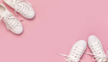 Pembe arka planda beyaz kadın moda ayakkabıları. Düz konum, üst görünüm, kopyalama alanı. Kadın ayakkabıları. Şık beyaz ayakkabılar. Moda blogu ya da dergi konsepti. Minimalist ayakkabı arkaplanı, spor ayakkabıları