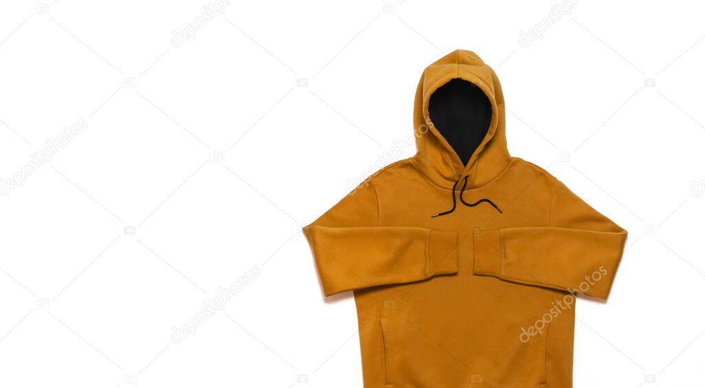 Yellow fashionable men's sweatshirt with a hood on white background top view. Fashionable male clothing, hoodie, casual youth style, sports. Hoody for design mockup for print. Blank sweatshirt mock up.