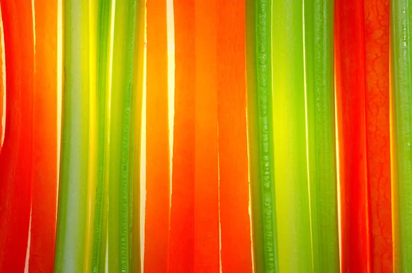Bright orange strips of fresh carrots and green celery. background
