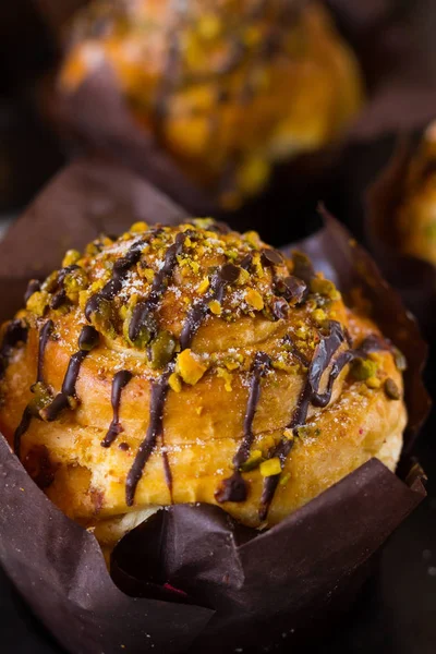 Big muffin with pistachio and chocolate icing