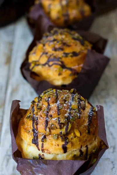 Three large crafting muffin with pistachio and chocolate
