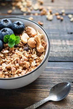 Homemade Chocolate Nut Granola with Fresh Blueberries.