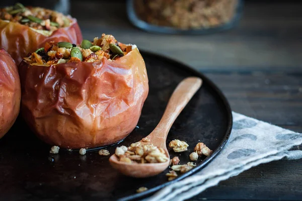 Baked apples with nut granola and pumpkin seeds. — Stock Photo, Image
