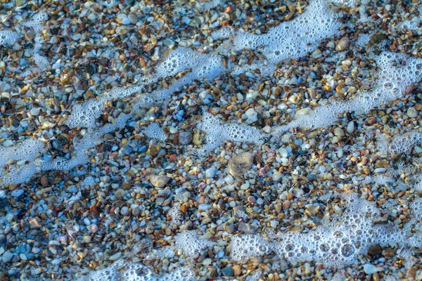 Морська галька кольоровий граніт на пляжі — стокове фото