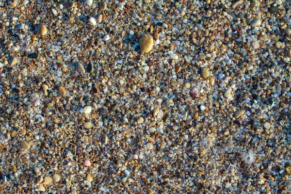 Sea pebbles colored granite on the beach — Stock Photo, Image