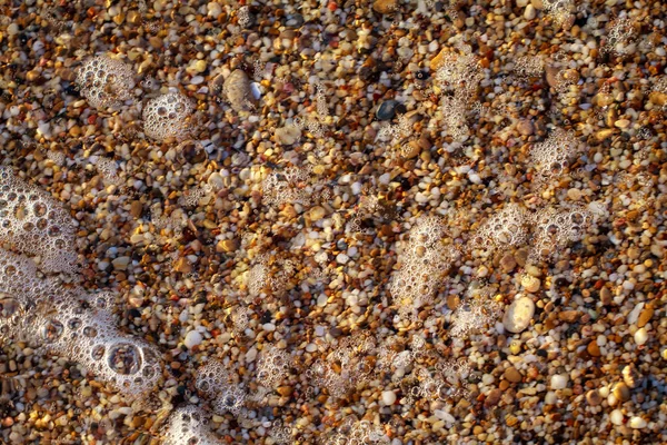Sea pebbles colored granite on the beach — Stock Photo, Image