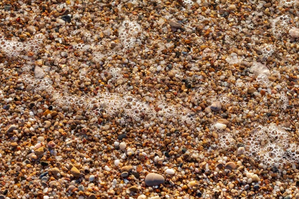 Sea pebbles colored granite on the beach — Stock Photo, Image