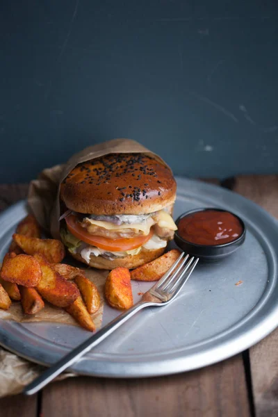 Burger with fried potato slices