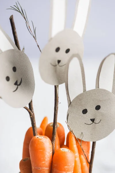 Carrots with paper bunnies faces