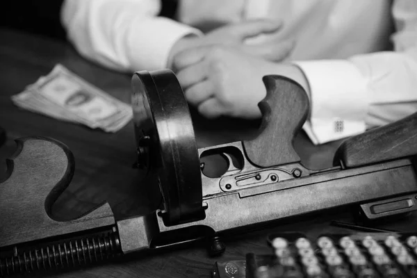 Businessman sitting with vintage gun — Stock Photo, Image