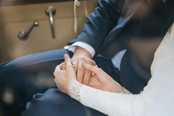 Happy bride couple holding hands — Stock Photo, Image