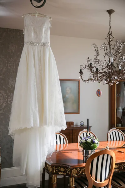 wedding dress hanging in room