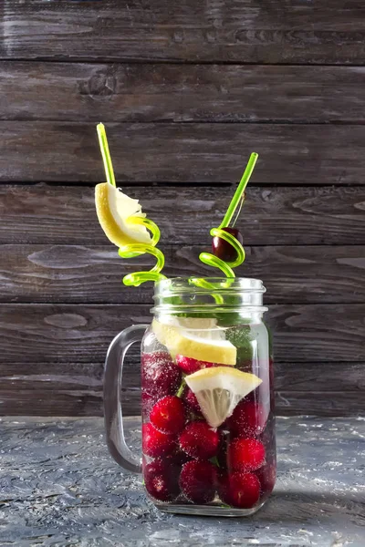 Fresh drink with cherry, mint and lemon — Stock Photo, Image