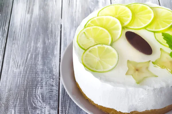 Gâteau rond beurre blanc sucré avec du citron vert tranché sur le dessus — Photo