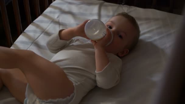 Μήκος σε πόδηα μωρό τρώει τροφές από ένα μπουκάλι. 4k — Αρχείο Βίντεο