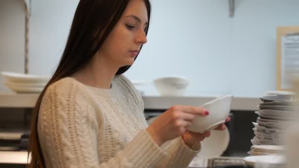 Žena koupí nádobí v úložišti. — Stock video
