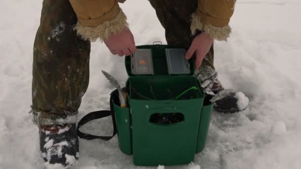 Fisherman pulls out a fishing rod out of the box — Stock Footage Fisherman pulls out a fishing rod out of the box Video Clip