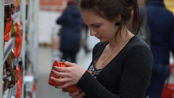 Женщина покупает кофе в супермаркете — стоковое фото