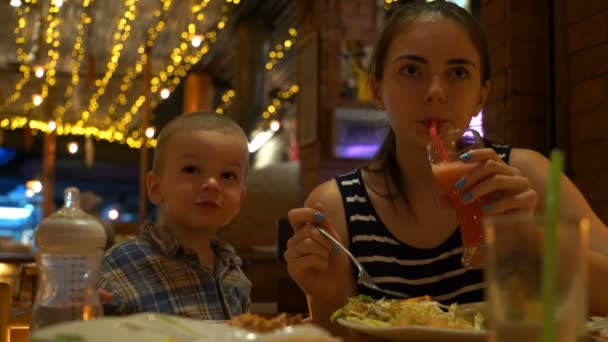 Filmación mamá e hijo comiendo en un café . — Vídeo de stock