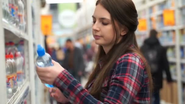 Filmación mujer compra jugo en el supermercado. Vídeo 4k . — Vídeos de Stock