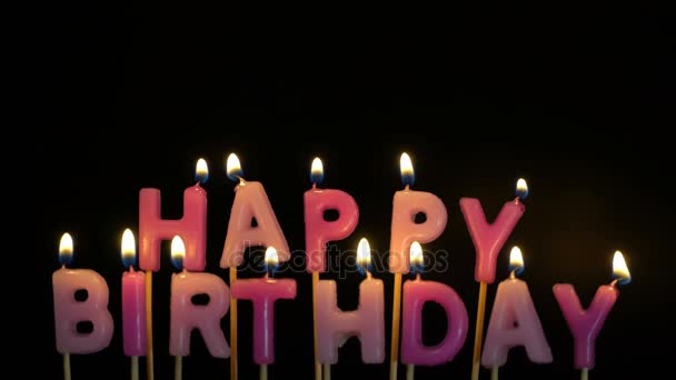 Footage colorful burning candles set on black background. Happy Birthday candles. — Stock Video