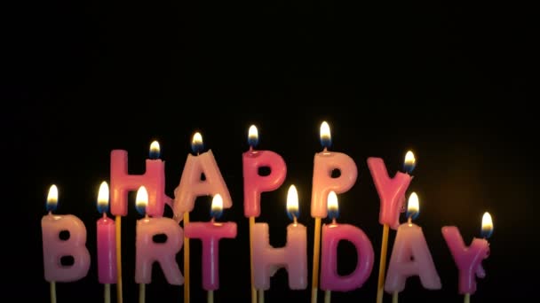 Footage colorful burning candles set on black background. Happy Birthday candles. — Stock Video