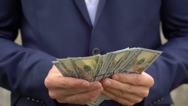 Young businessman shows his money close-up. — Stock Video