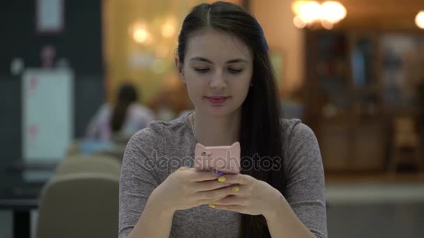 그의 스마트폰에 메시지를 입력 하는 젊은 여자. — 비디오