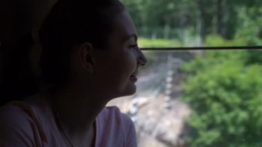 Bir kadın bir tren sürme ve pencereden dışarı bakıp.