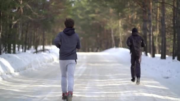 Jeune athlète masculin jogging en bois d'hiver — Video