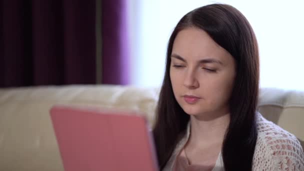 Woman in a Medical Mask Uses a Tablet at Home During Quarantine — Stock Video