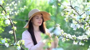 Güzel genç bayan bahar bahçesinin tadını çıkarıyor..
