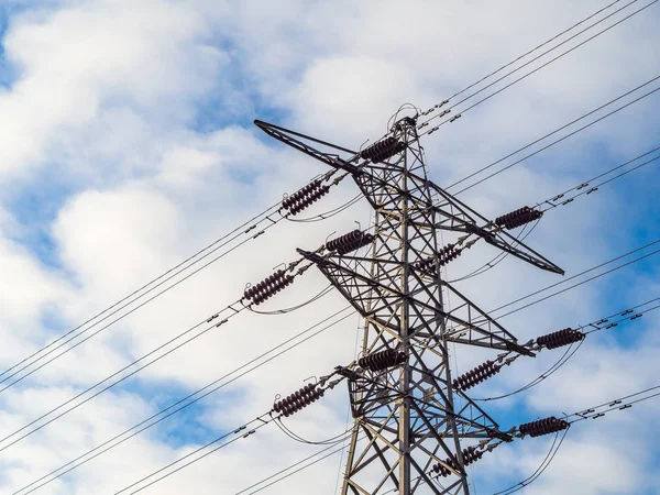 Electricity supply pylon against bright cloudy sky — Stock Photo, Image