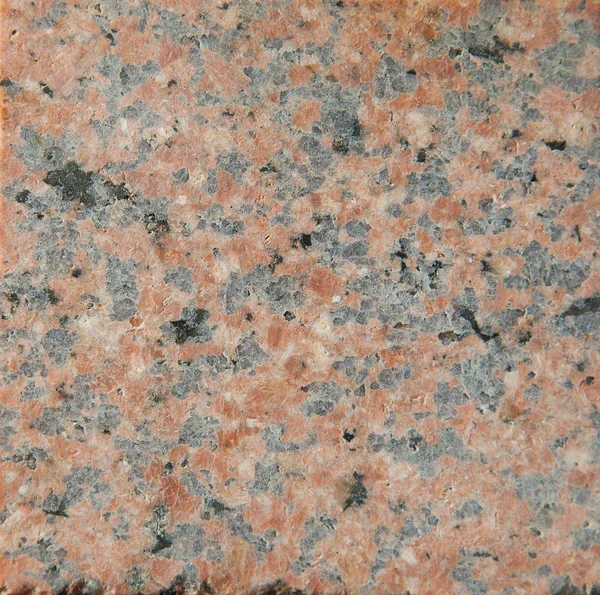 Background of unpolished mat grainy pale red granite with fine venous structure and additions of black and white colors — Stock Photo, Image