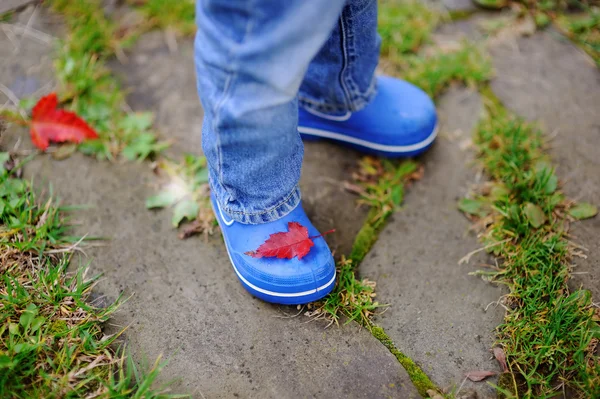 Close up photo of child legs in rubber boots — Stock Photo, Image