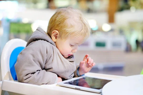 Toddler boy playing with a digital tablet — Stock Photo, Image