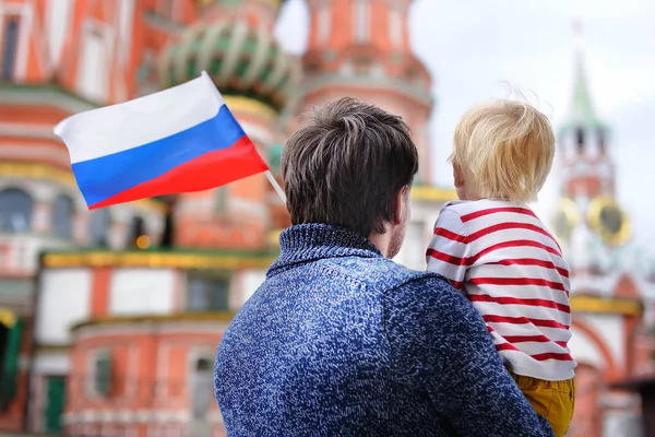 Little boy and his middle age father holding russian flag — Stock Photo, Image