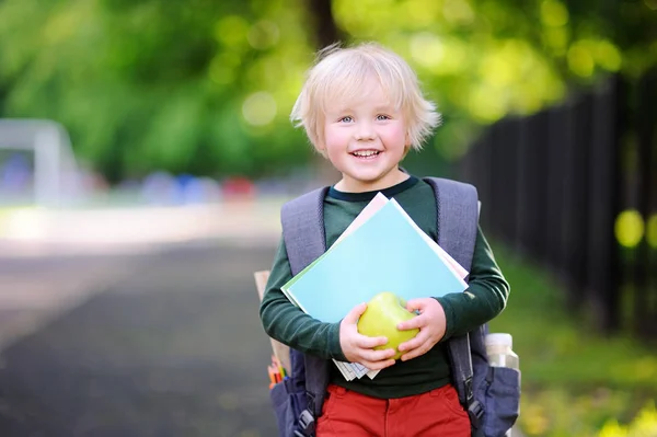 Joli petit écolier avec son sac à dos et sa pomme. Concept de retour à l'école . — Photo